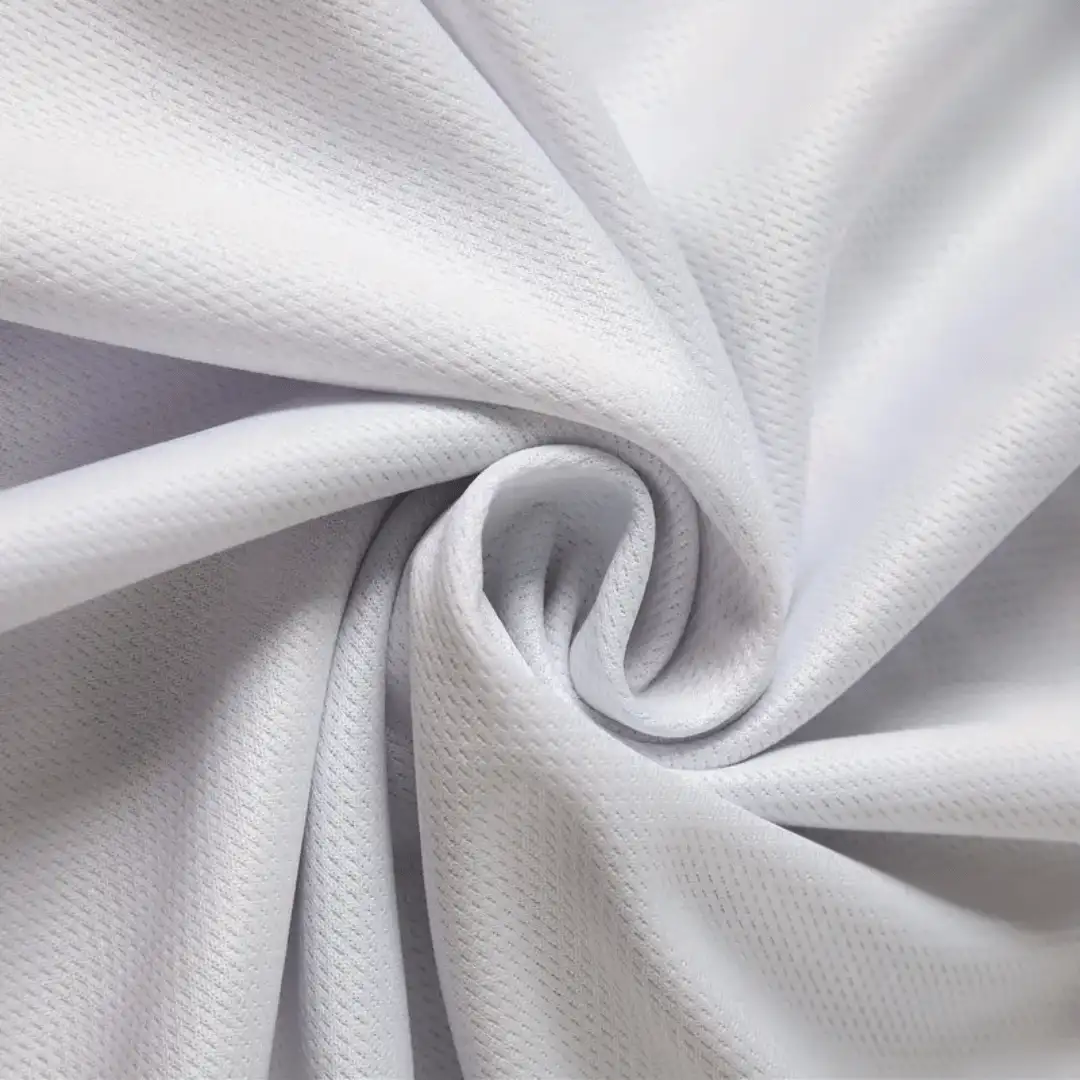 Lembaran kain Milano dengan tekstur rajut rapi dan permukaan lembut, tersedia dalam berbagai gramasi.